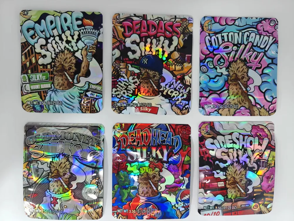 Six flat three-side seal tobacco pouch designs with zipper tops laid out on a white surface